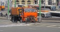 Watering machine orange color washes the streets of Moscow