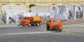 Watering machine orange color washes the streets of Moscow