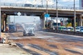 Watering machines waters a working section of the road on a hot sunny day