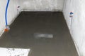 Watering a newly poured floor screed at home to prevent it from cracking.