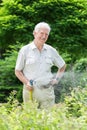 Watering plants using hose Royalty Free Stock Photo