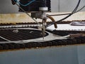 Waterjet cuts stainless steel sheet