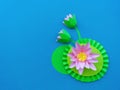 Waterlily flower made of paper. Blue background. Origami hobby. Gentle petal. Copy spase Royalty Free Stock Photo