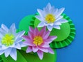 Waterlily flower made of paper. Blue background. Origami hobby. Gentle petal Royalty Free Stock Photo