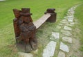 Carved wooden waterman while serving as a bench