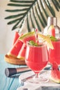 Watermelon cocktail with mint and ice. Summer refreshing drinks in glasses on blue wooden table. Concept of healthy summer eating Royalty Free Stock Photo