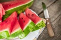 Watermelon cuts with wooden knife