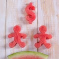 Watermelon in dollar form and man. Slice of watermelon with money and people