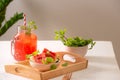 Watermelon drink in glass with slices of watermelon on whitebackground