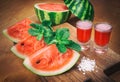 Watermelon drink watermelon pieces in a rustic wooden background. Royalty Free Stock Photo