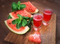 Watermelon drink watermelon pieces in a rustic wooden background. Royalty Free Stock Photo