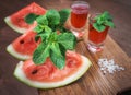 Watermelon drink watermelon pieces in a rustic wooden background. Royalty Free Stock Photo