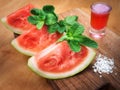 Watermelon drink watermelon pieces in a rustic wooden background. Royalty Free Stock Photo