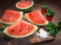 Watermelon drink watermelon pieces in a rustic wooden background. Royalty Free Stock Photo