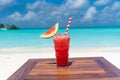 Watermelon fresh juice with ice and strawa on the wooden table ocean background at the beach Royalty Free Stock Photo