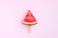 Watermelon fruit sliced with wood ice cream stick on pink background Royalty Free Stock Photo