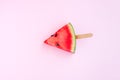 Watermelon fruit sliced with wood ice cream stick on pink background Royalty Free Stock Photo