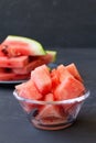 Watermelon in a glass bowl on the black background