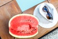 Watermelon and glasses near the pool