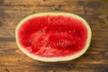 Watermelon half on rustic table