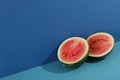 Watermelon halves on two tone background, space for text Royalty Free Stock Photo