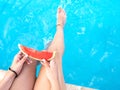 Watermelon in the hand of a girl in swimming pool Royalty Free Stock Photo