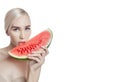 Watermelon in hands of women, clean smooth skin of body and face. Blonde girl in summer holding a watermelon in hands of face. Royalty Free Stock Photo