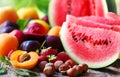 Watermelon, hazelnuts, apricots and strawberries on table Royalty Free Stock Photo