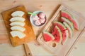 Watermelon ice cream in bowl and cutted fruits near on wooden table Royalty Free Stock Photo