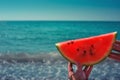Watermelon, juicy, red slice in the hands of a woman against the background of the ocean Royalty Free Stock Photo