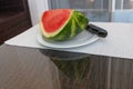 Watermelon with knife on a plate Royalty Free Stock Photo