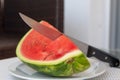 Watermelon with knife on a plate Royalty Free Stock Photo