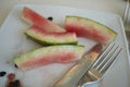 Watermelon leftovers and cutlery