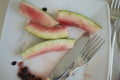 Watermelon leftovers and cutlery