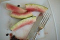 Watermelon leftovers and cutlery