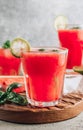 Watermelon lemonade with lime and fresh basil leaves on concrete background. Refreshing summer drink Royalty Free Stock Photo