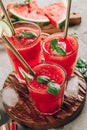 Watermelon lemonade with lime and fresh basil leaves on concrete background. Refreshing summer drink Royalty Free Stock Photo