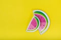 Watermelon-like plate on yellow background