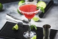 Watermelon margarita, alcoholic cocktail with silver tequila, lime juice, mint, watermelon and crushed ice, metal bar tools, gray