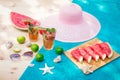 Watermelon mojito cocktail, cutted watermelon, limes, starfishes, seashells, sunglasses and hat on wooden surface Royalty Free Stock Photo