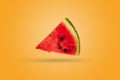 Watermelon on an orange background. Ripe slice of fresh watermelon with pulp and green peel. Royalty Free Stock Photo