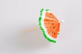 Watermelon paper cocktail drink umbrella on grey background