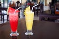 Watermelon and pineapple shakes close up, sliced fruits pieces, straw, two fruit shakes with garnish in transparent glasses Royalty Free Stock Photo