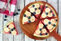 Watermelon pizza with bananas, blueberries and yogurt on serving board