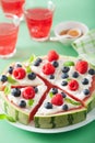 Watermelon pizza slices with yogurt and berries, summer dessert