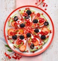 Watermelon pizza, vegetarian, fruit  pizza with creamy natural yogurt and fresh fruits  on a plate, on a white wooden table, top v Royalty Free Stock Photo