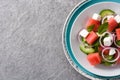 Watermelon salad with feta cheese,mint,onion and cucumber on gray background. Royalty Free Stock Photo