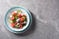 Watermelon salad with feta cheese,mint,onion and cucumber on gray background. Royalty Free Stock Photo