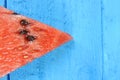 Watermelon slice on blue wooden background. Fruits, freshness, summer concept