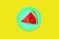 Watermelon slice on a colored background. Round plate of menthol on a yellow background. Contemporary art collage